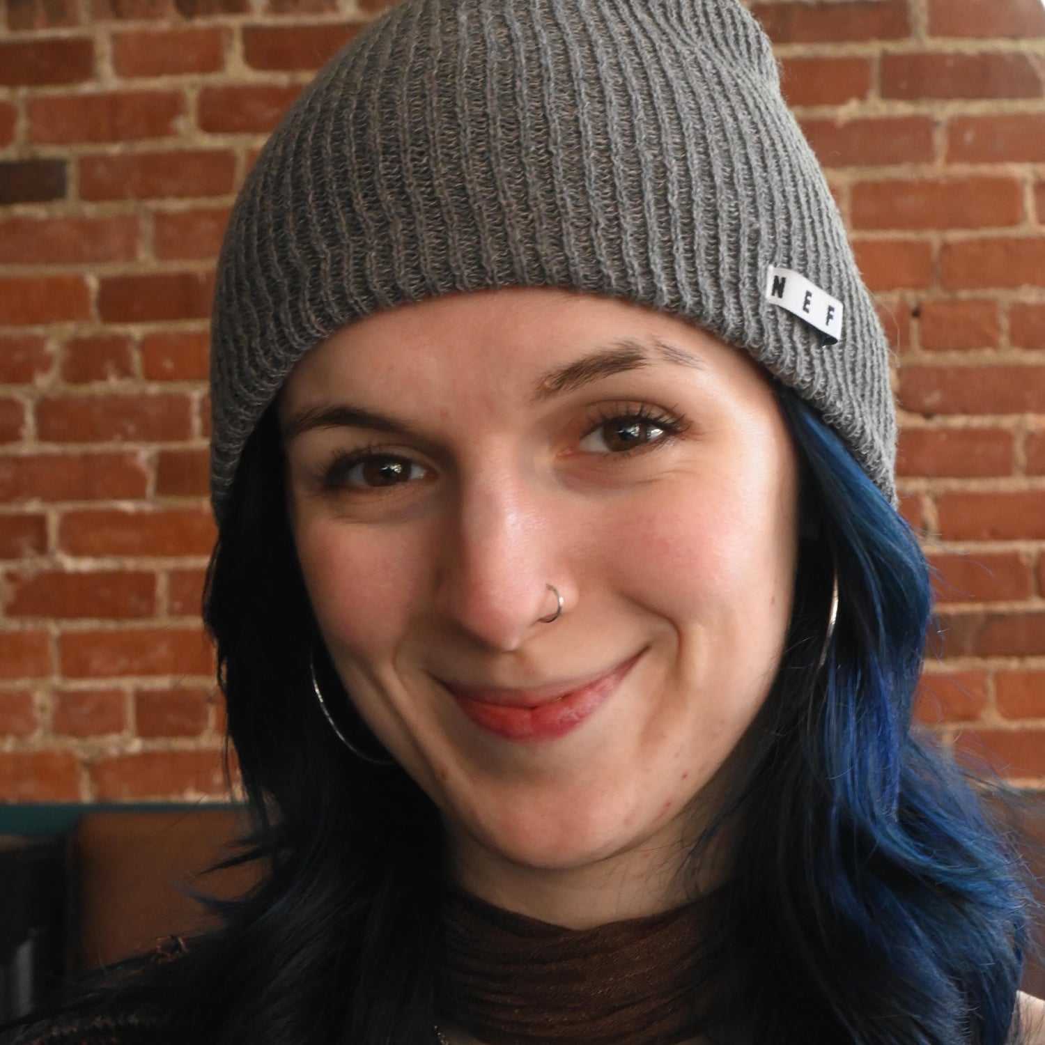 Portrait of Madilin, a professional stylist at Somerby's Hair Salon, showcasing their expertise and style.