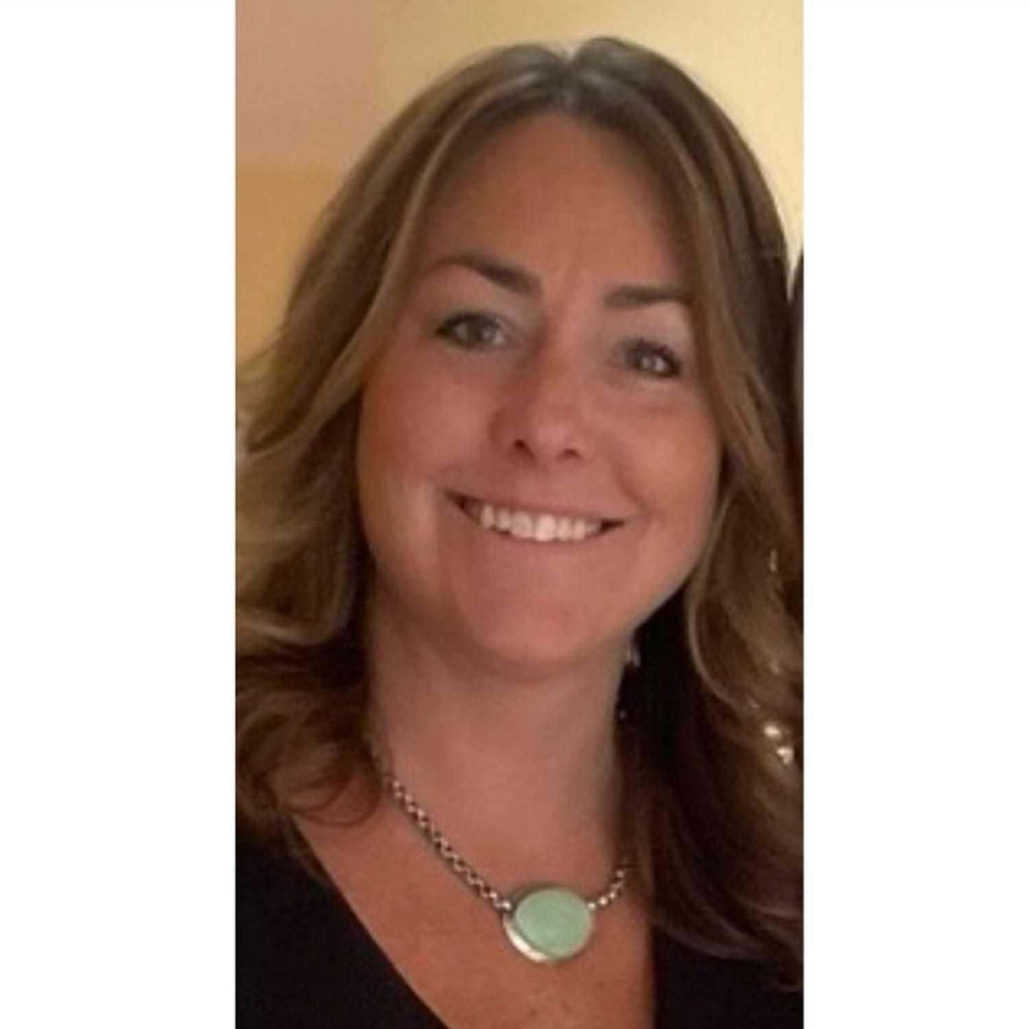 Portrait of Stacie, a professional stylist at Somerby's Hair Salon, showcasing their expertise and style.